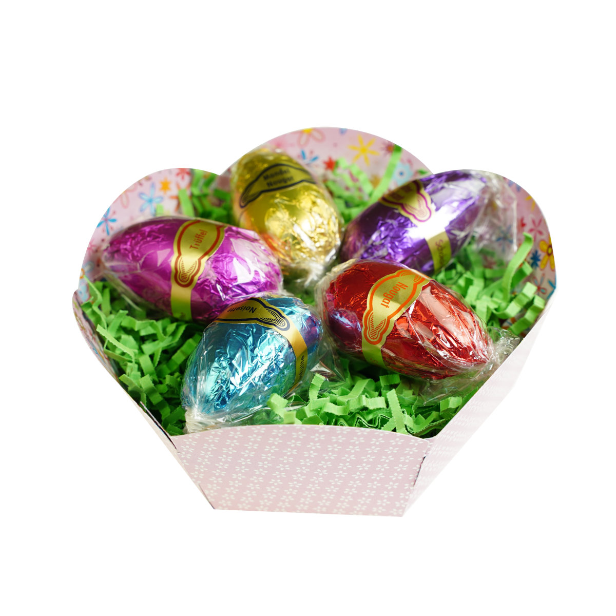 Dessert-Ei-5-st-Netz Fuenf in bunte Folie gewickelte Schokoladeneier liegen auf gruenem Papier in einer rosa Box. Texte: 'Nougat', 'Marzipan'.