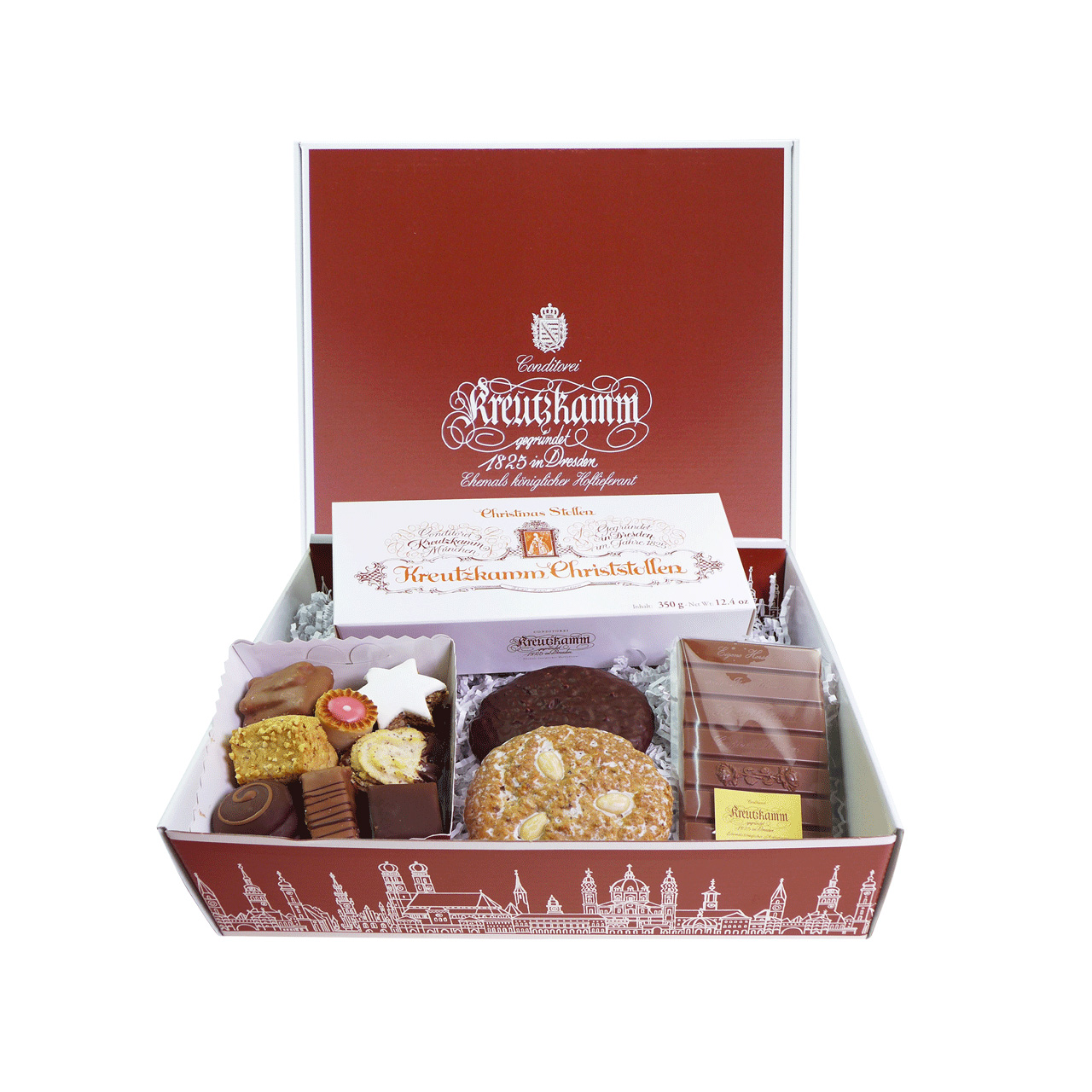 Weihnachtspaket-2 Geschenkbox mit Suessigkeiten, darunter Pralinen, Gebaeck, Schokolade und Christstollen, in geoeffneter, roter Verpackung. Text: "Kreutzkamm"