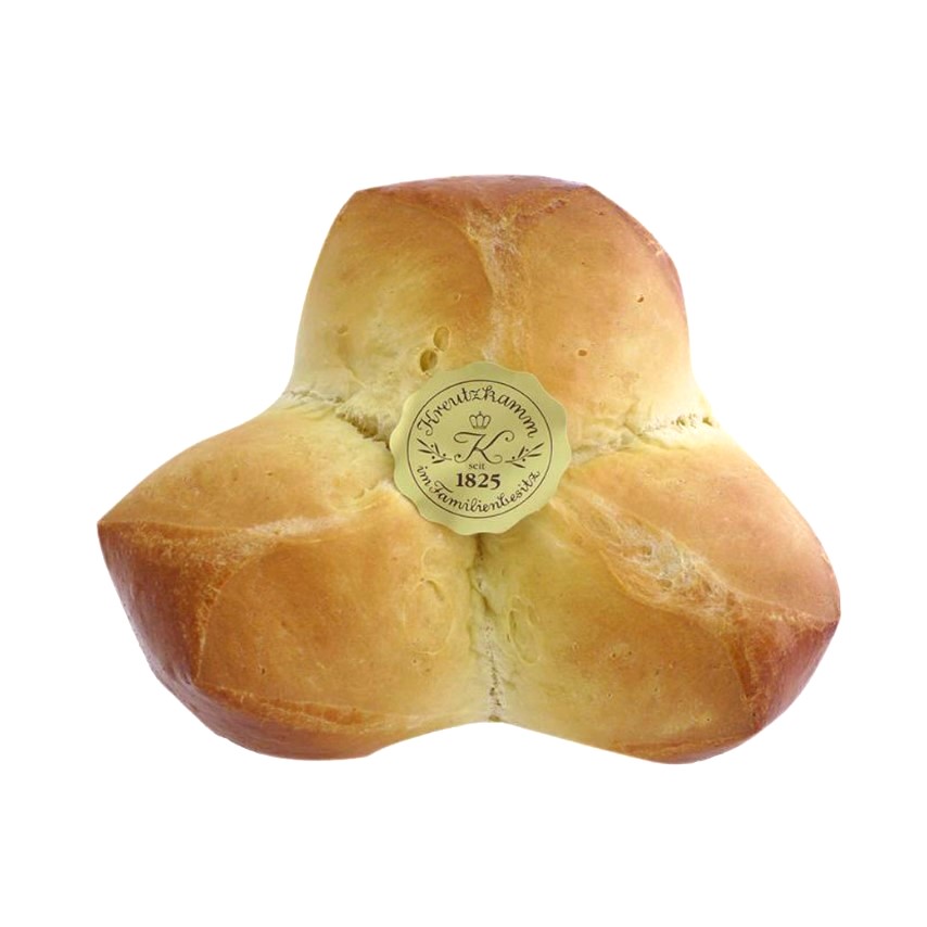 Ein Brotlaib in Form eines vierteiligen Kleeblatts. Text auf Etikett: "Backhaus Kreutzkamm seit 1825 im Familienbesitz".